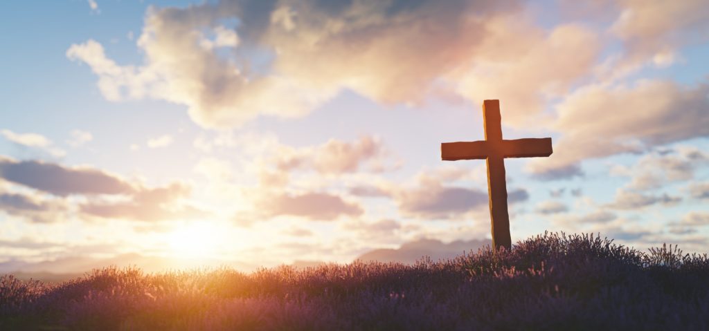 Cross at sunset religion and faith